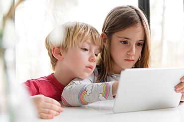 Children looking at tablet together