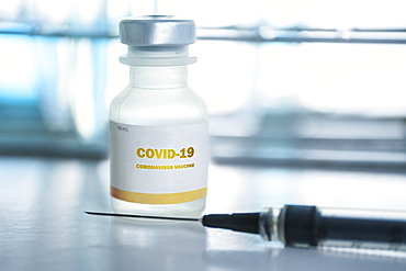 Vial of covid-19 vaccine and hypodermic needle