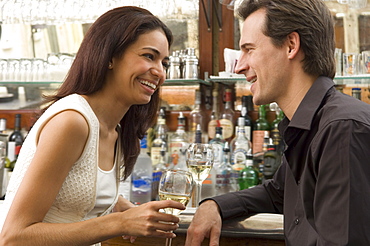 Couple talking at bar