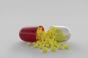 Studio shot of capsule with yellow pills inside