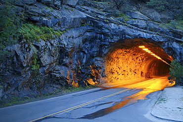 Illuminated tunnel in mountains