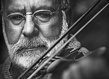 Mature man playing violin