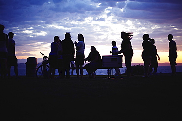 Silhouettes of people during party at twilight