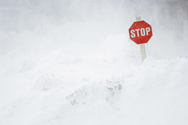 Stop sign in snow bank