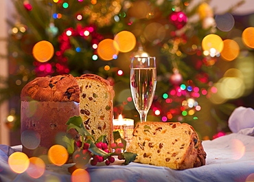 Panettone and glass of white wine on Christmas table