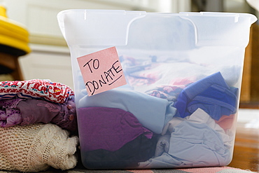 Clothes in bin marked for donation