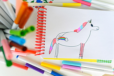 Child's drawing on unicorn with rainbow