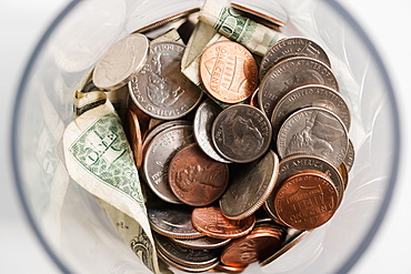 Overhead view of American cents and banknotes in jar