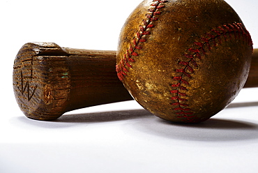 Studio shot of old baseball bat and ball