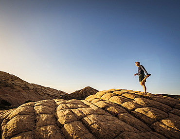 USA, Utah, St. George, Man exercising in rocky landscape