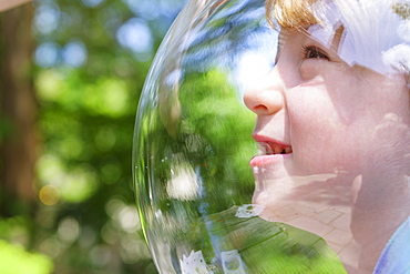 Boy wearing bubble outdoors to socially distance