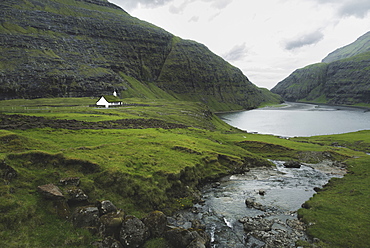 Denmark, Small church in green landscape with mountains