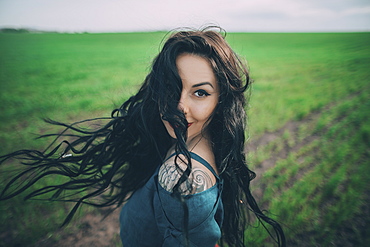 Young woman dancing in field