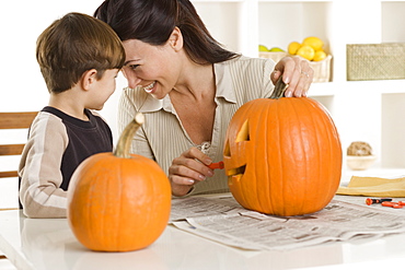 Mother and son carving pumpkin