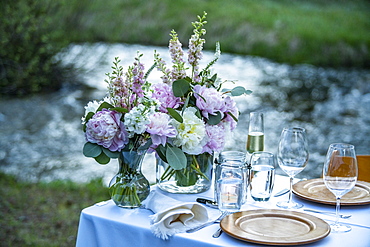 Outdoor dinner table setting with fresh flowers