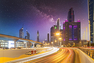 United Arab Emirates, Dubai, Traffic on highway and modern city architecture at dusk