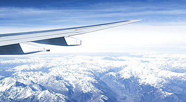 Switzerland, Canton Wallis, Airplane wing over snowy mountains