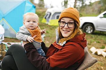 USA, Utah, Uninta Wasatch Cache National Forest, Mother holding son (6-11 months) on campsite