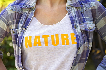 Midsection of girl (6-7) wearing nature t-shirt