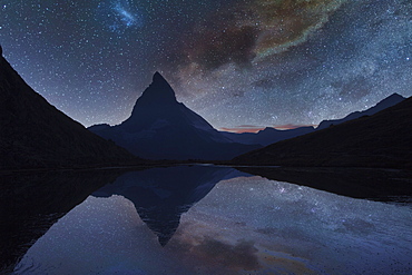 Switzerland, Canton Wallis, Zermatt, Matterhorn, Milky Way over Matterhorn reflecting in Riffelsee Lake