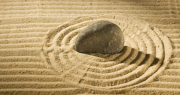 Still life of a stone on sand