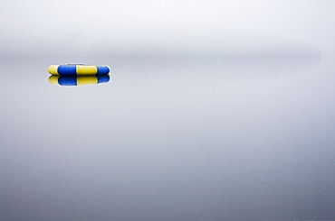 Floatie on foggy lake