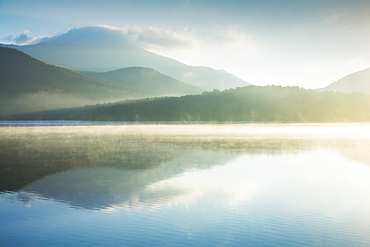 USA, New York, North Elba, Lake Placid, Morning mist rising on Lake Placid