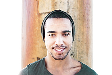 Smiling Hispanic man wearing cap