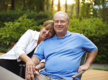 Caucasian couple sitting together and holding hands