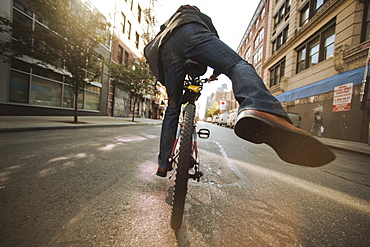 Caucasian man riding bicycle on urban street