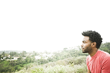 African American man sitting on hilltop