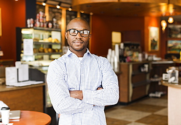 Black man standing in coffee shop