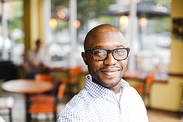 Black man smiling in coffee shop