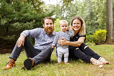 Portrait of young family, outdoors, smiling