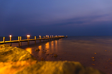 View of sea and pier at night, Kep, Cambodia
