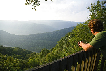 Mid adult man looking at view from viewing platform, rear view, New River Gorge National River, Fayetteville, West Virginia, USA