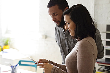 Colleagues looking at digital tablet Small Business, Start-up