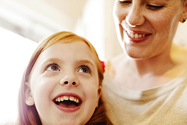 Close up of girl and mother in kitchen