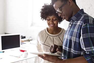 Young man and woman using digital tablet