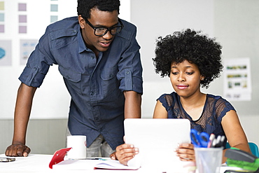 Two colleagues working with digital tablet