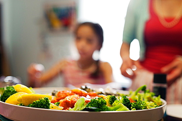 Dish of broccoli and lemon pieces in tomato sauce