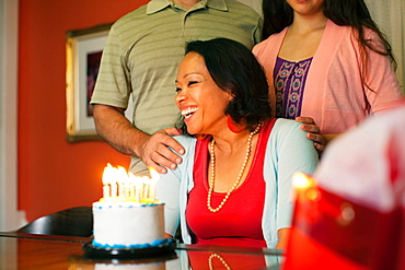 Woman smiling over birthday cake