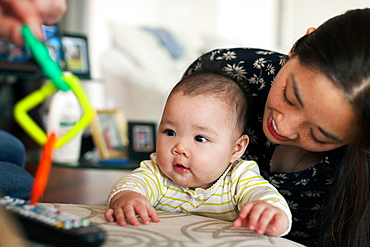 Close up of parents playing with baby daughter