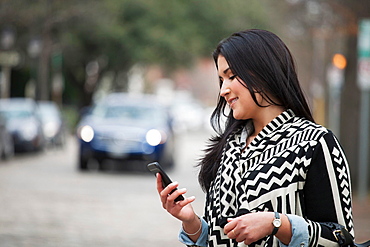 Young woman holding cell phone