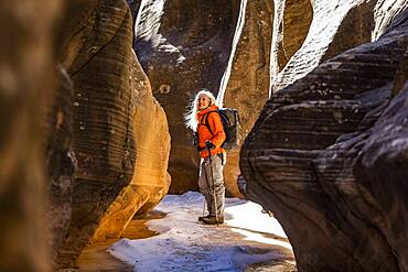 USA, Utah, Escalante, Woman hiking in slot canyon in Grand Staircase-Escalante National Monument