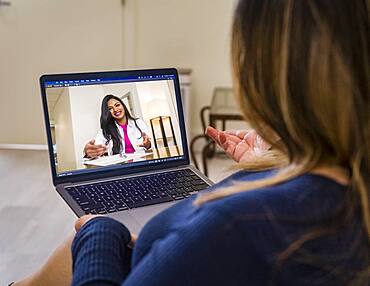 Woman having video call with doctor