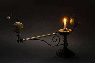 Antique globe and candle solar system model