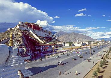 China, Tibet, Lhasa, Potala Palace and traffic on road