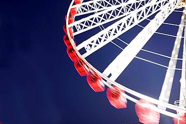 Low angle view of spinning ferris wheel
