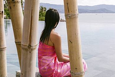 Thailand, Koh Samui Island, Woman looking at calm tropical landscape